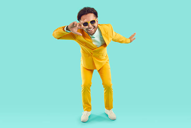 istock Cool funny man showing v-sign and looking at you through it on light blue background in studio. 2242415322