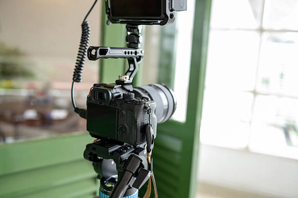 istock A professional video camera setup for studio filming is mounted on a tripod, accompanied by a casing, monitor, and other equipment in a studio setting 2242416050