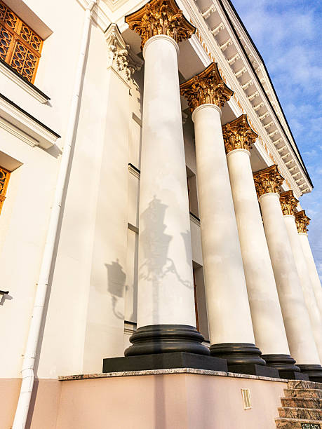 istock Architectural columns with ornate details and shadows cast on a building facade in soft sunlight 2242416648