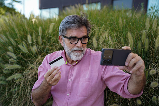 istock Senior man using credit card for online payment with smartphone 2242419263