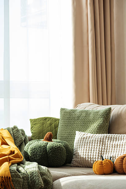 istock Autumn Sofa Styling with Textured Pillows, Fabric Pumpkins, and Cozy Blankets 2242420290