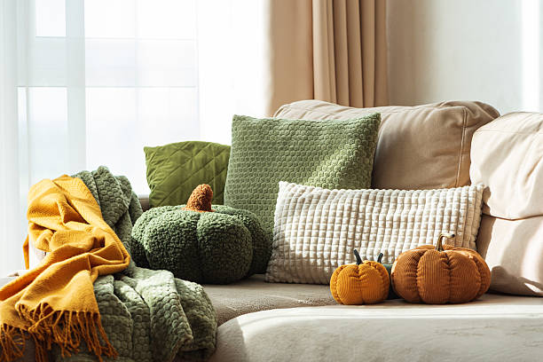 istock Autumn Sofa Styling with Textured Pillows, Fabric Pumpkins, and Cozy Blankets 2242420292