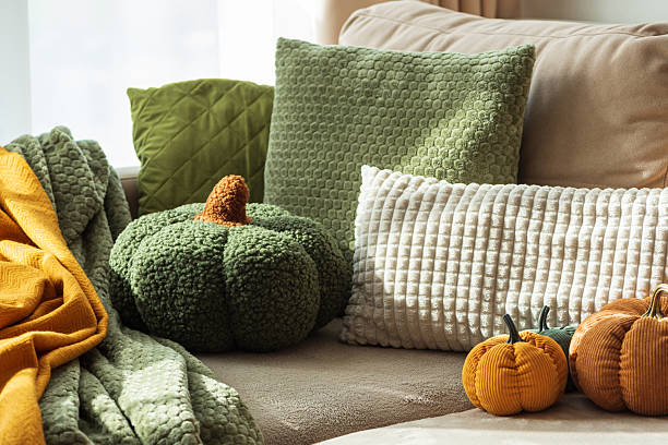 istock Autumn Sofa Styling with Textured Pillows, Fabric Pumpkins, and Cozy Blankets 2242420294