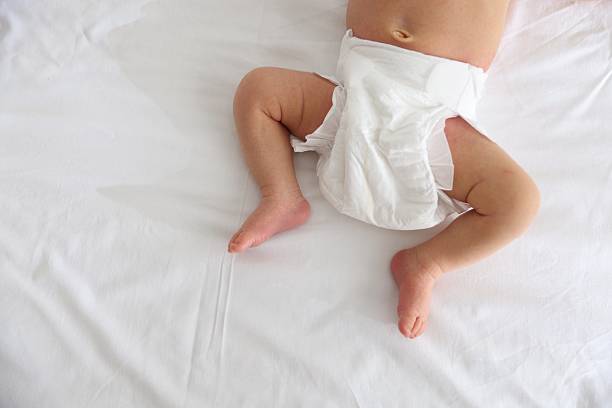 istock Cute newborn baby lying on bed, top view. Space for text 2242421637
