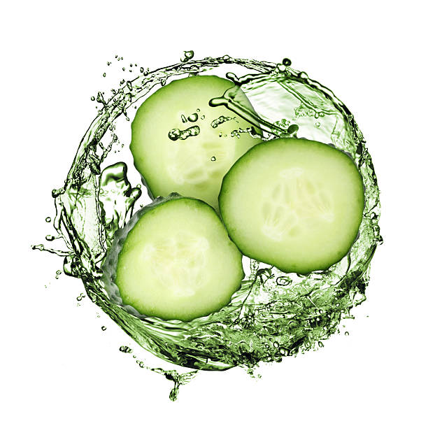istock Cucumber slices and splash against white background 2242425047