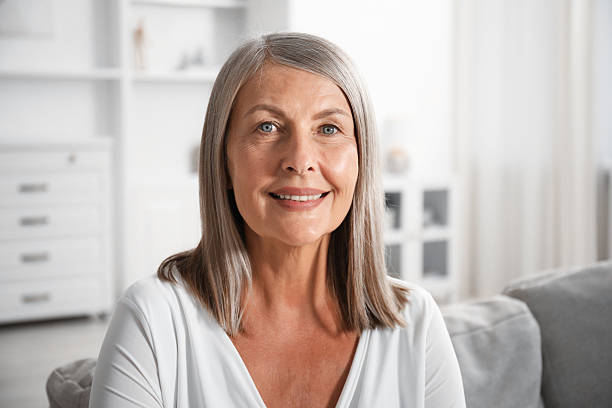 istock Elegant senior woman on sofa at home 2242426516