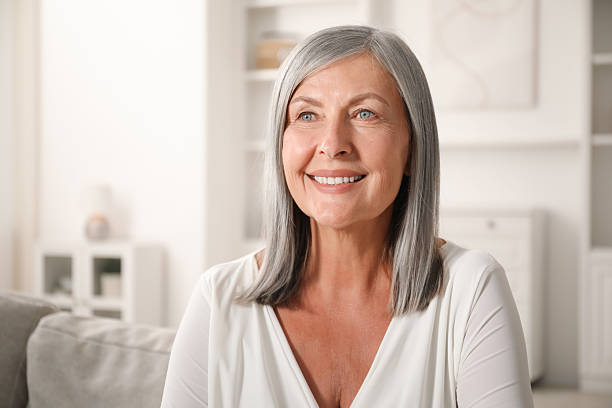 istock Elegant senior woman on sofa at home. Space for text 2242426855