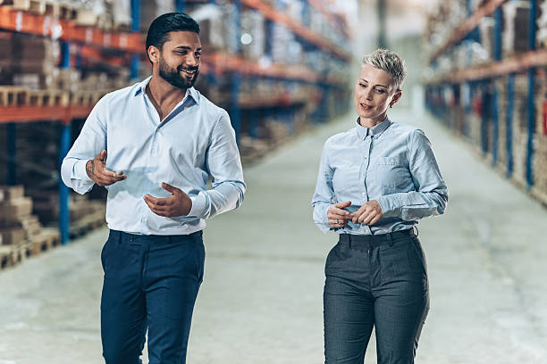 istock Business managers walking side by side and talking 2242427031