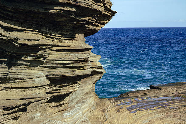 istock Layered coastal cliffs by blue ocean on sunny day 2242428889