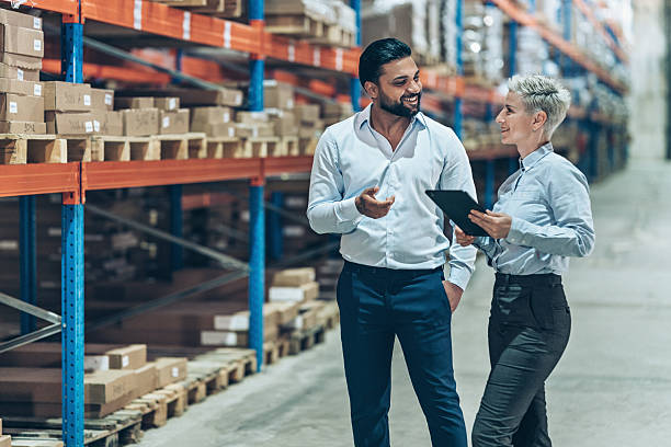 istock Business managers organizing the export containers in a warehouse 2242429083