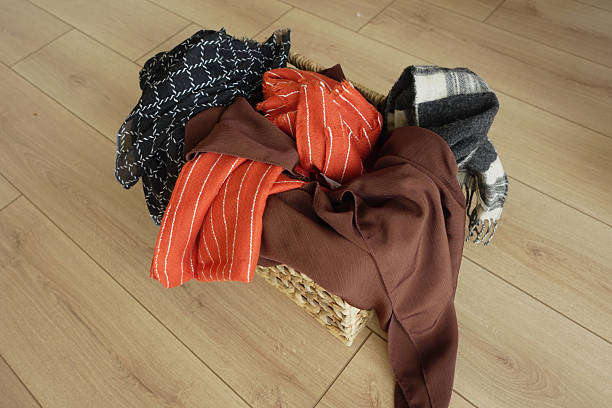 istock Colorful fabrics arranged in a woven basket indoors 2242433420