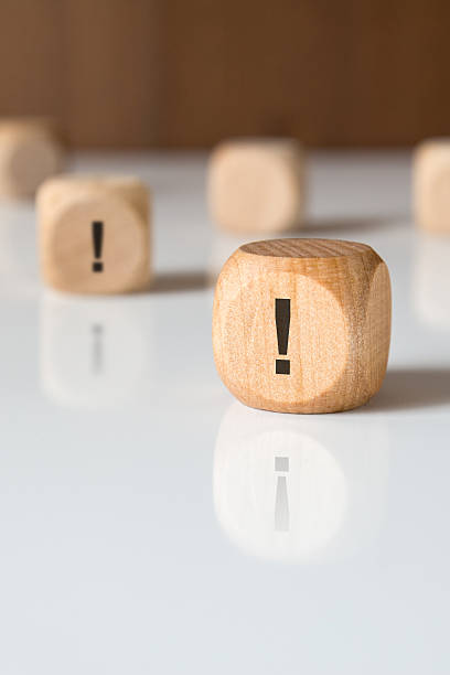 istock Wooden cube with exclamation mark on white surface, concept of attention or alertness 2242433801