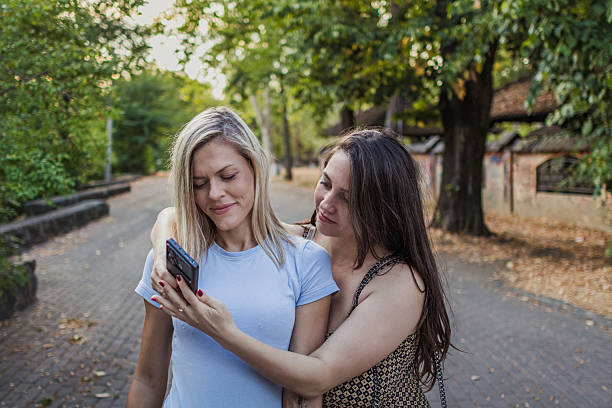 istock Connection and bonding between two female friends in the public park. 2242437029