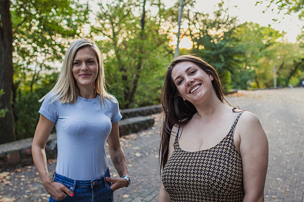 istock Connection and bonding between two female friends in the public park. 2242437242