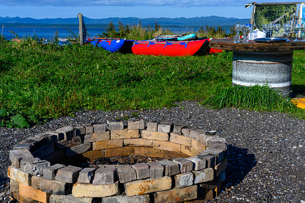 istock Gathering at the cozy fire pit near sparkling waters under a bright blue sky 2242440434