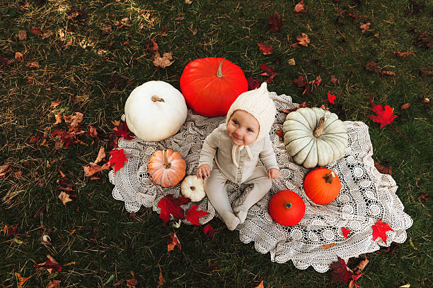Baby Girl Sitting with Pumpkins