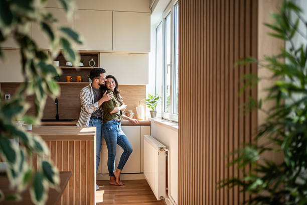 istock Happy couple hugging in modern minimalist kitchen 2242445370