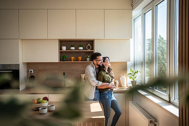 istock Happy young couple embracing in modern kitchen 2242445517