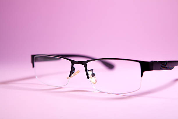 istock Glasses on a pink background close-up. Glasses for vision correction. 2242445610