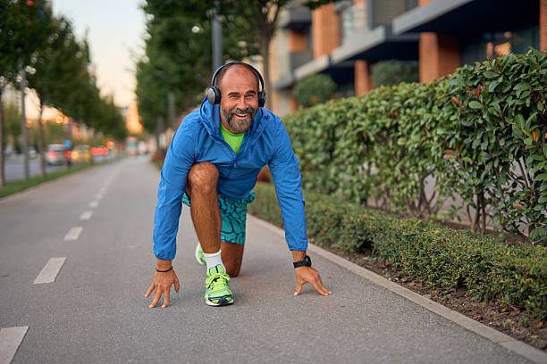 istock Mature man in starting position for urban run 2242446662