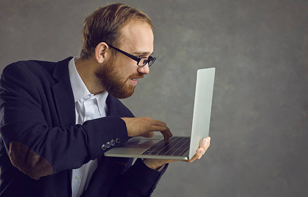 istock A man is typing on a laptop side view. 2242446772