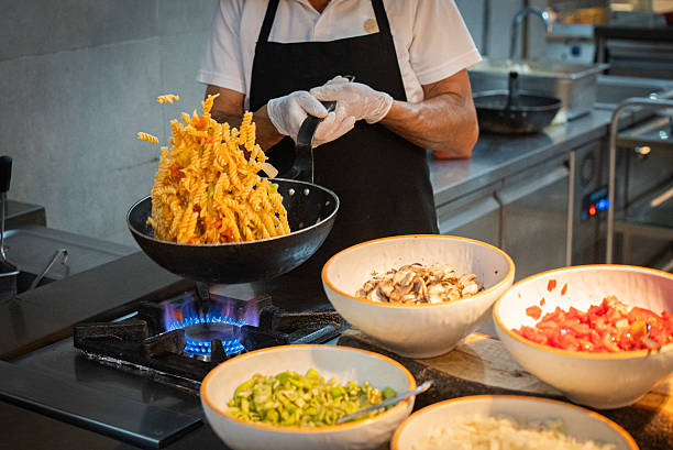 istock Chef hands preparing delicious vegetable pasta in fast food restaurant 2242449293