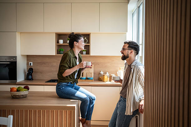 istock Happy couple enjoying morning coffee and conversation in kitchen 2242449865