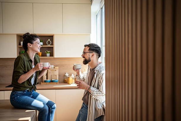 istock Happy couple enjoying coffee and morning talk in kitchen 2242450414