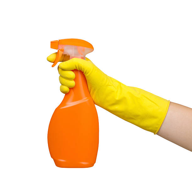 istock Hand in Yellow Glove Holding Spray Bottle Isolated 2242450597
