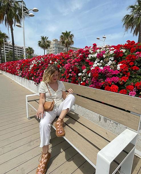 istock Blonde Woman sitting on a bench 2242452025