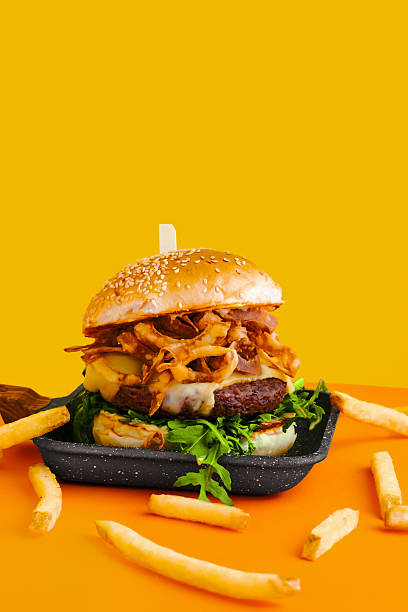 istock Burger on Yellow with Fries 2242457491