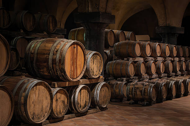 istock Ancient wooden barrels in historic wine cellar for aging 2242458438
