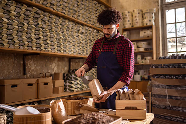 istock Portrait Of An Artisan Worker Packaging Coffee Beans In A Rustic Workshop Setting 2242459592