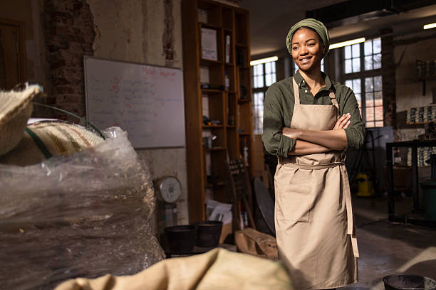 istock Confident Woman In Apron Standing In Creative Workshop Studio With Arms Crossed 2242459883