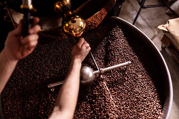 istock Roasting Coffee Beans By Hand In A Large Roaster With A Metal Stirring Arm 2242459958