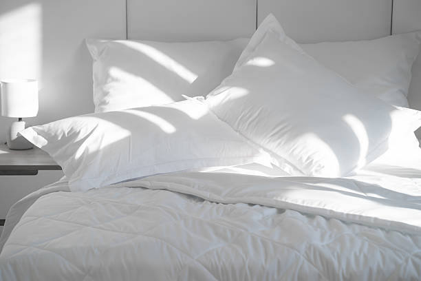 Shot of clean pillows neatly arranged on a double bed.