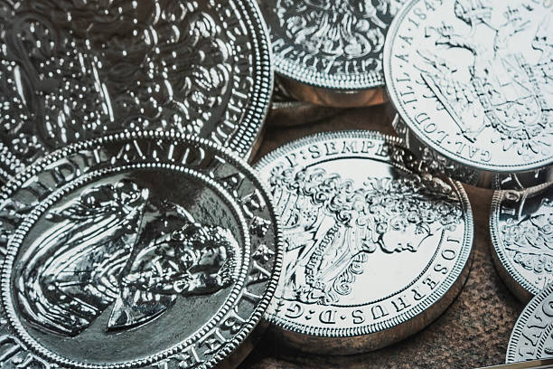 PRAGUE,CZECH REPUBLIC, 10.08.2025: Detailed view of multiple shiny silver antique coins with engraved portraits and inscriptions. For numismatics, history, collecting, and vintage currency research.
