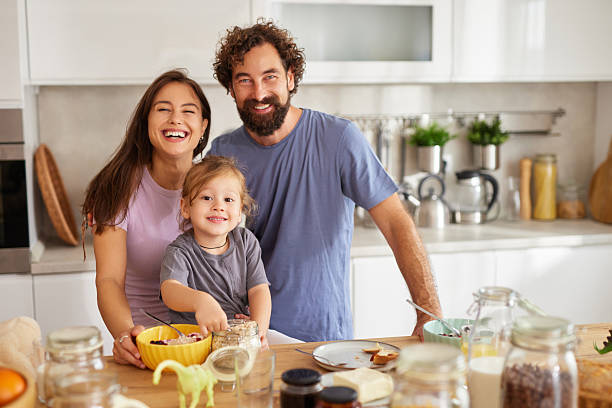 istock Happy family enjoying breakfast together in modern kitchen 2242463610