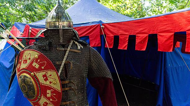 istock A complete set of medieval knight armor with a shield standing in a blue and red tent during a historical reenactment festival 2242467747