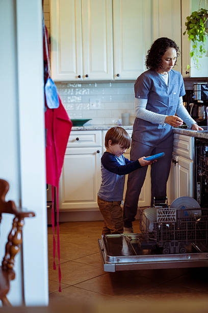 istock Little boy helping his mom with the dishes 2242468807