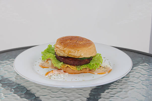 istock Delicious Minimalist Beef Burger on White Plate 2242469640