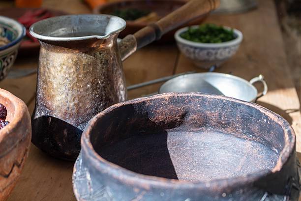 istock Ancient ceramic bowl and traditional copper cezve for coffee preparation on rustic wooden table 2242469668