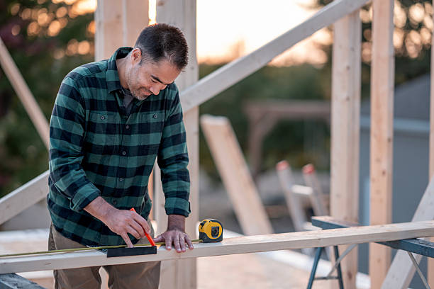 istock Hispanic Man Building Wooden Framework Outdoors At Construction Site With Tape Measure 2242470978