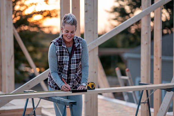 istock Smiling Older Woman Builder Works On Home Construction Project At Sunset 2242471037
