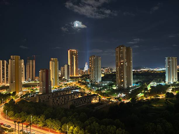 istock night skyline with illuminated towers, nighttime cityscape featuring bright beams and glowing 2242471310