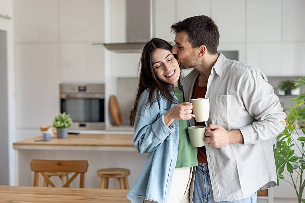 istock Cheerful Couple Sharing a Loving Moment in Cozy Kitchen 2242471802