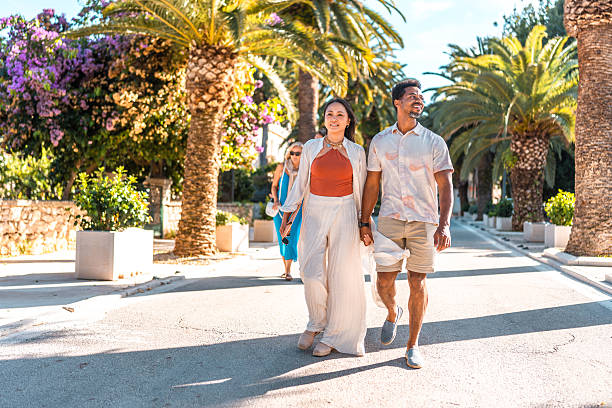istock Joyful Diverse Couple Strolling Coastal Promenade 2242471846