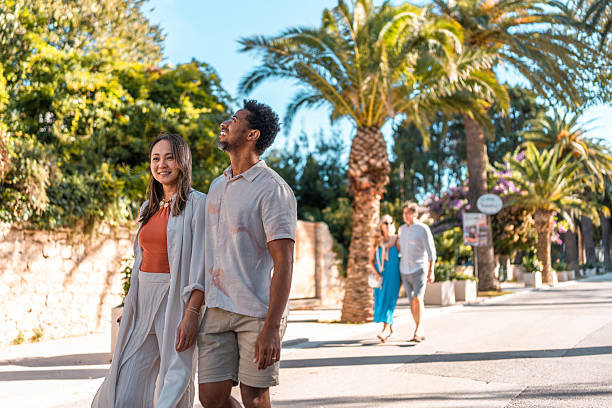 istock Diverse Couples Strolling in Coastal Promenade 2242471850