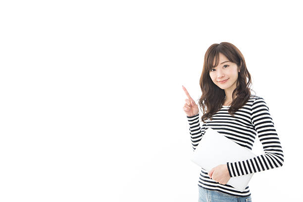 istock A woman holding a laptop and pointing 2242474170