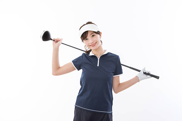 Golf ball against background of hitting woman closeup. Active healthy lifestyle concept